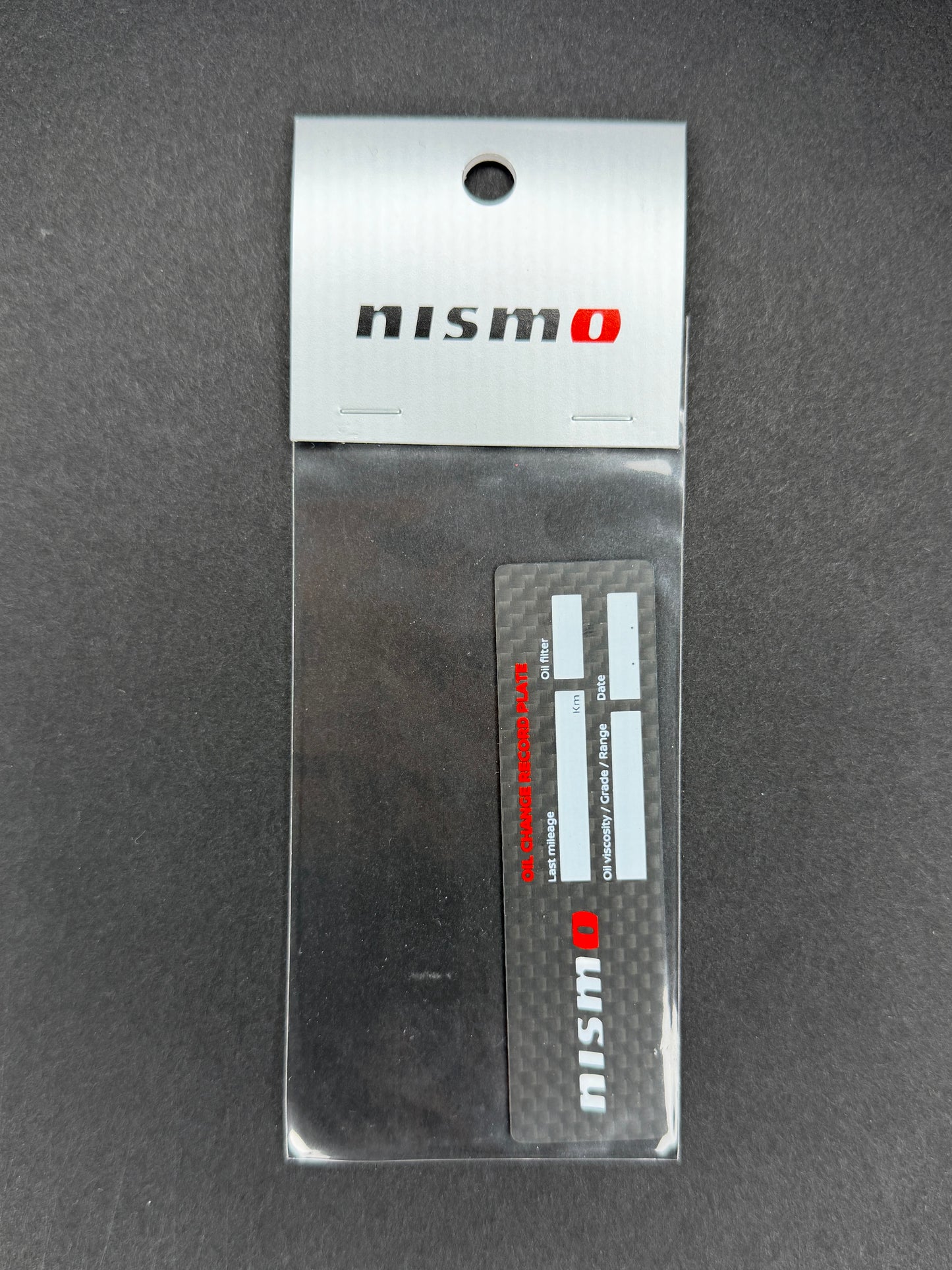 Nismo Oil Change Record Plate Carbon - KWAA0-50P00